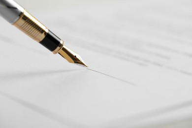 Photo of Signing document with fountain pen, closeup. Notary services