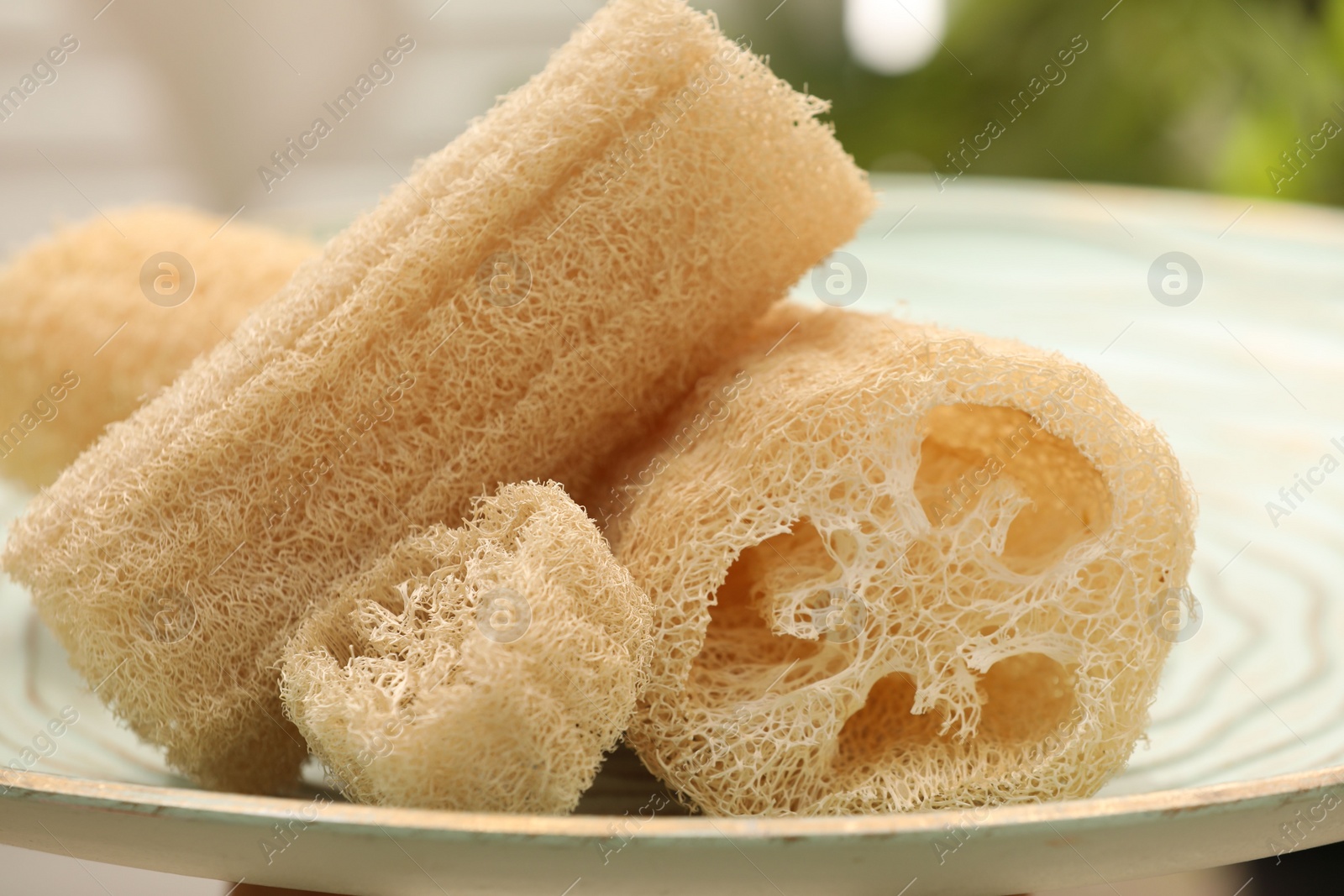 Photo of Loofah sponges on table indoors, closeup. Personal hygiene products