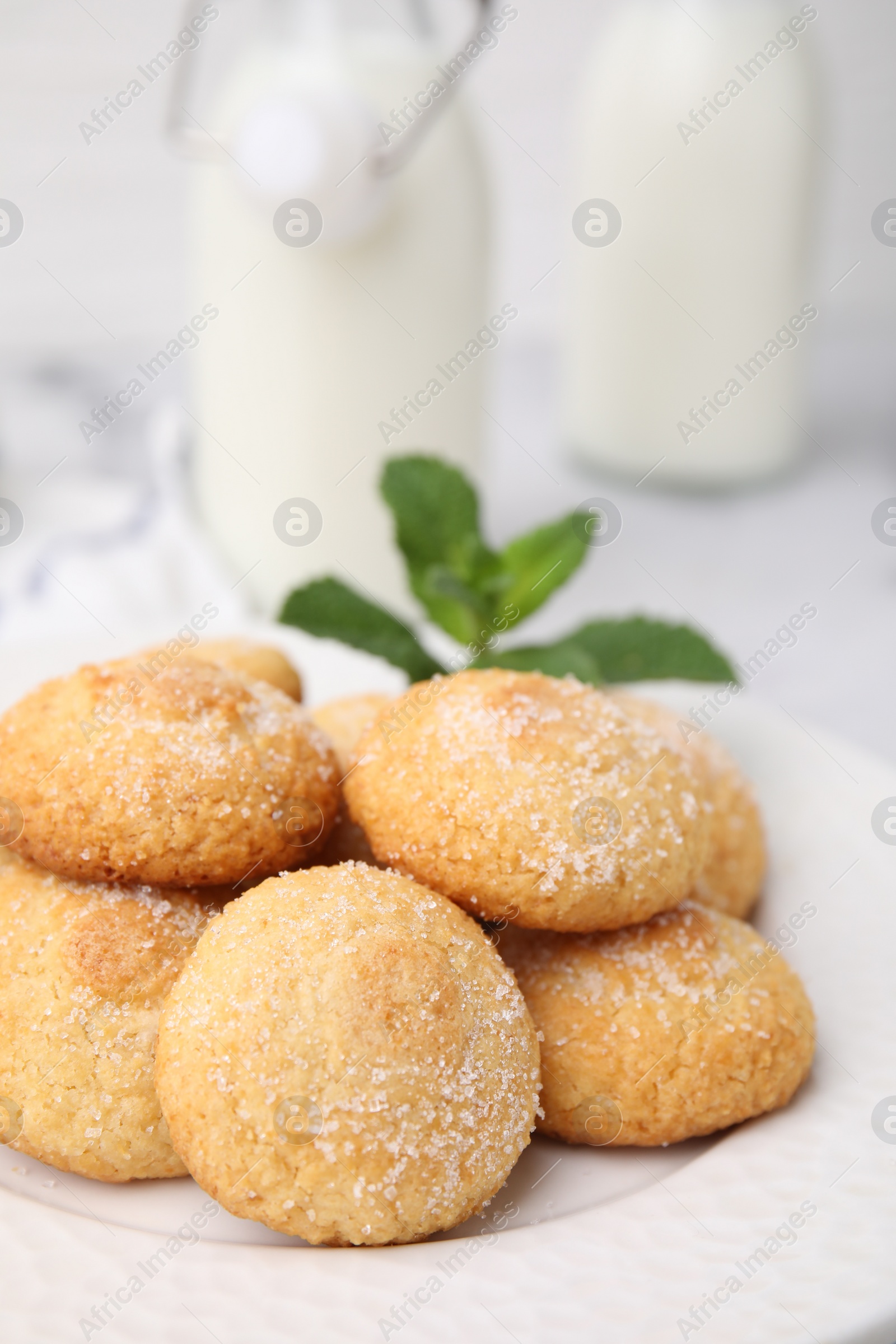 Photo of Tasty sweet sugar cookies and mint on table, closeup