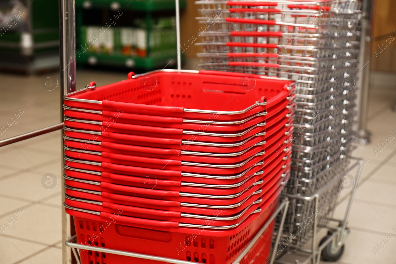 Photo of Stack of empty shopping baskets in supermarket, closeup