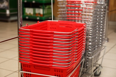 Stack of empty shopping baskets in supermarket, closeup