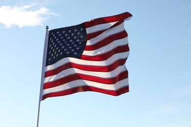 Photo of American flag fluttering outdoors on sunny day