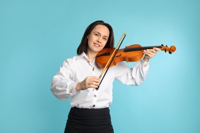 Photo of Music teacher playing violin on turquoise background