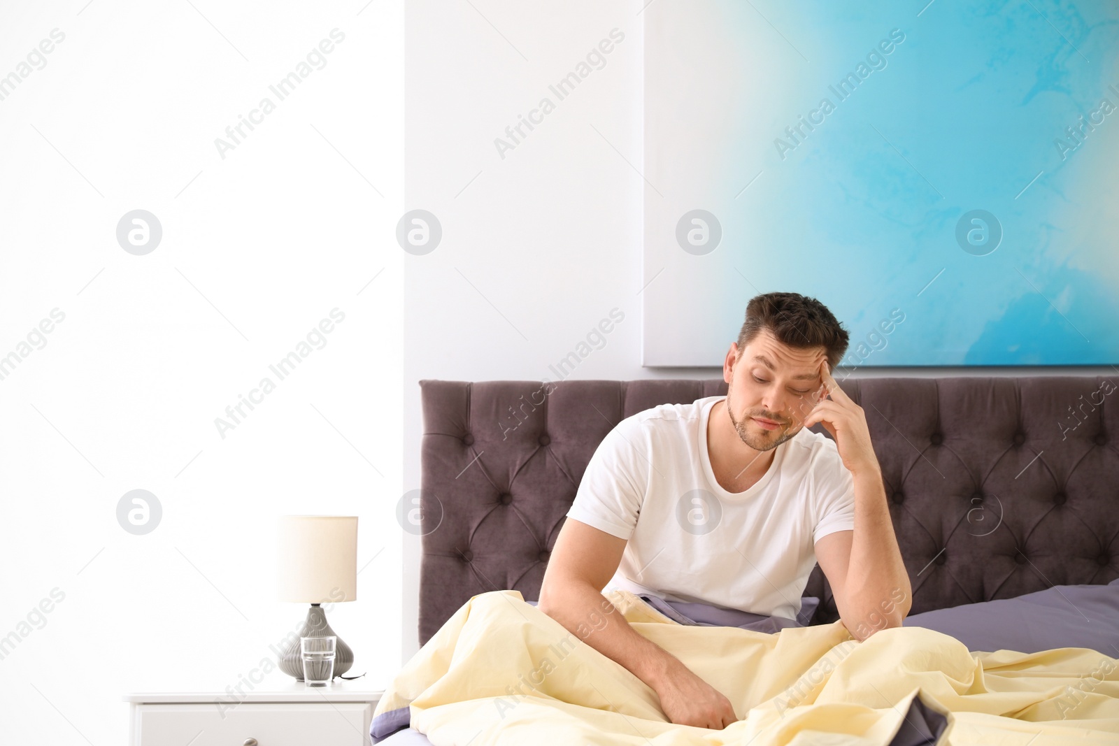 Photo of Sleepy man at home in morning, space for text. Bedtime