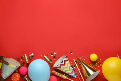 Photo of Beautiful flat lay composition with festive items on red background, space for text. Surprise party concept
