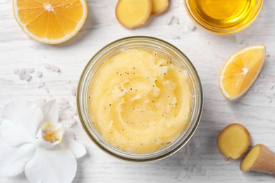 Photo of Flat lay composition with body scrub in glass jar on white wooden table