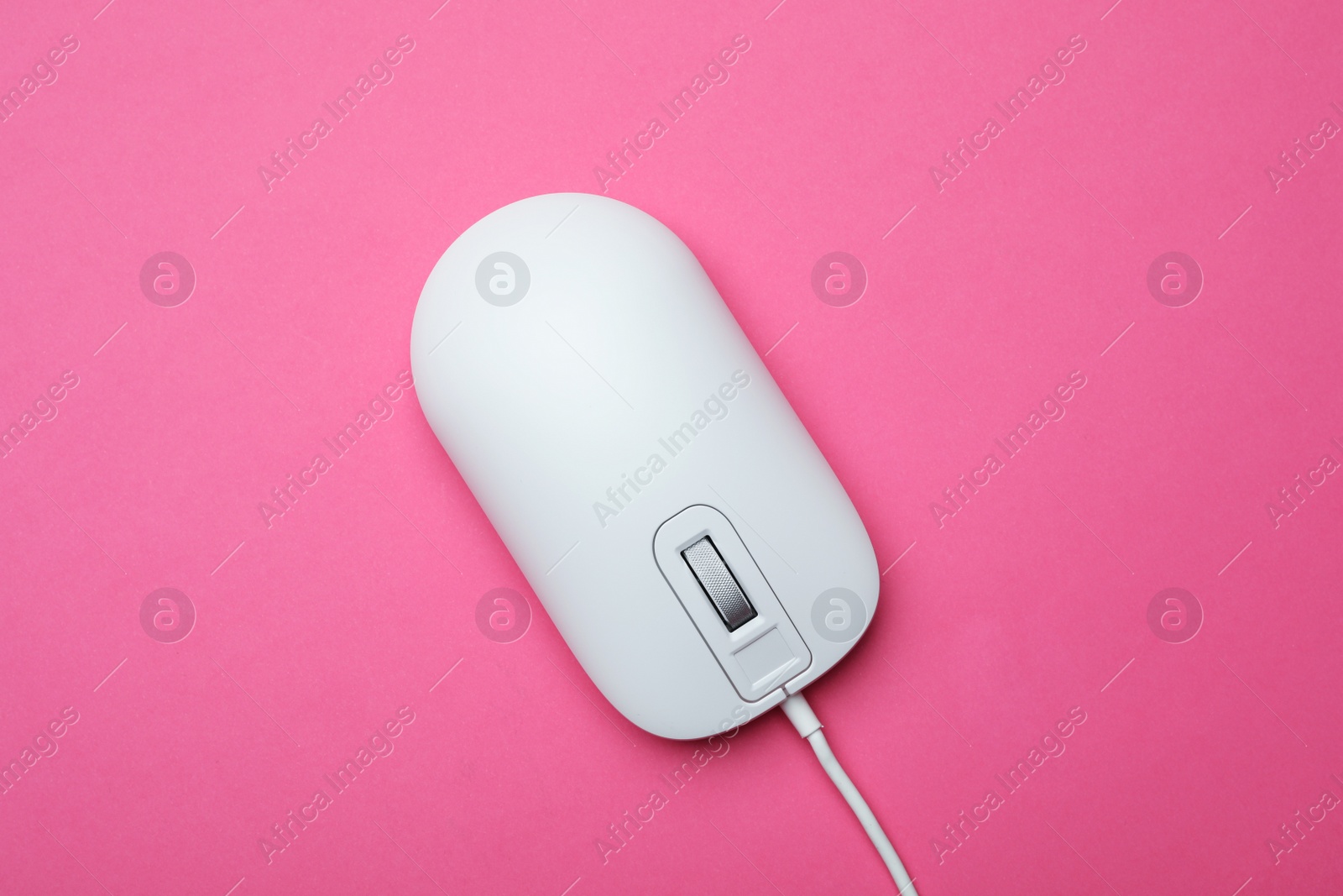 Photo of Wired computer mouse on pink background, top view