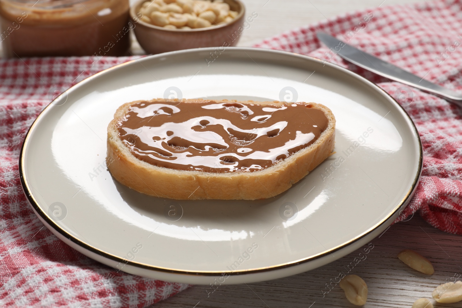 Photo of Toast with tasty nut butter on table, closeup