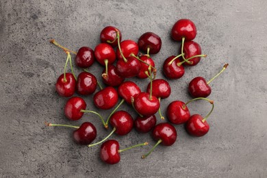 Photo of Many sweet cherries on grey table, flat lay