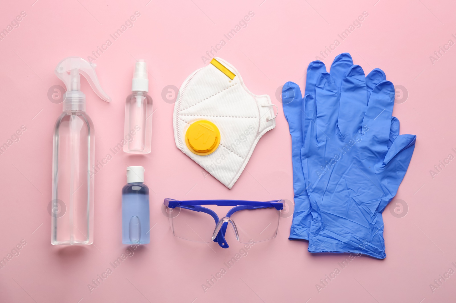 Photo of Flat lay composition with medical gloves, mask and hand sanitizers on pink background