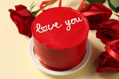 Photo of Bento cake with text Love You and red roses on beige table, closeup. St. Valentine's day surprise