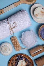 Flat lay composition with different spa products on light blue background