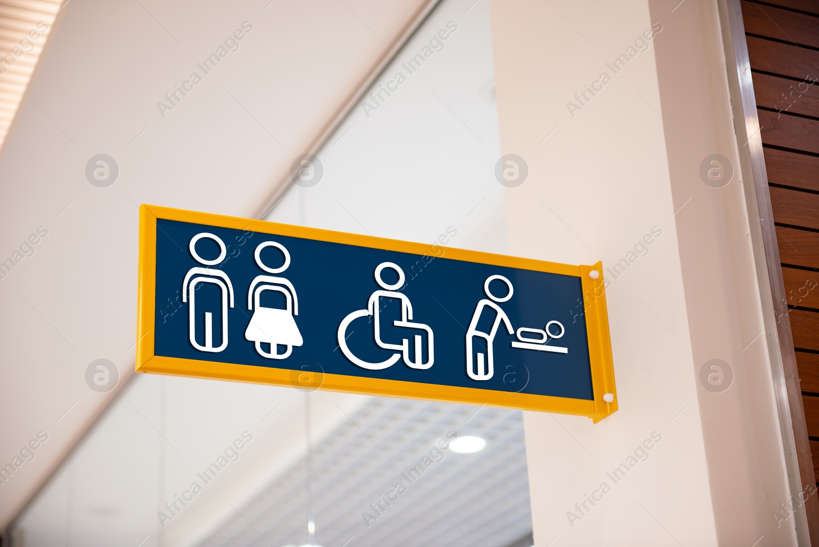 Image of Blue public toilet sign on wall indoors