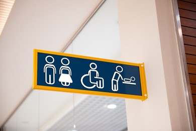 Image of Blue public toilet sign on wall indoors