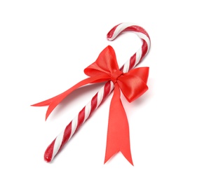 Photo of Tasty candy cane with bow on white background. Festive treat