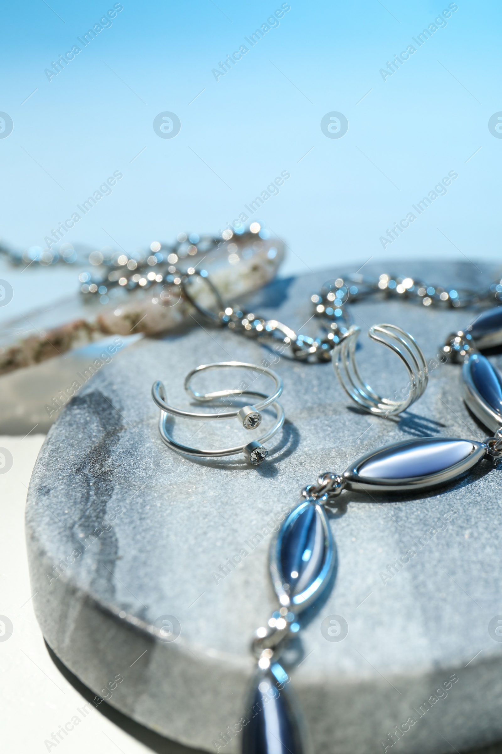 Photo of Stylish presentation of beautiful jewelry on color background