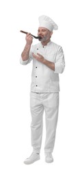 Chef in uniform tasting something on white background