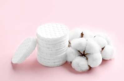 Photo of Composition with cotton pads and flowers on color background