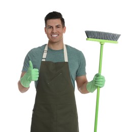 Photo of Man with green broom on white background