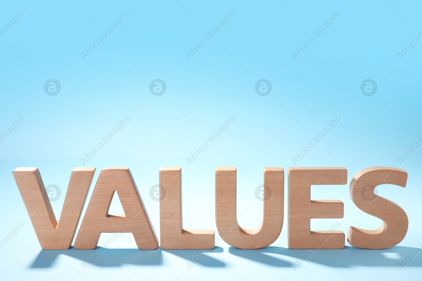 Photo of Word VALUES made of wooden letters on light blue background