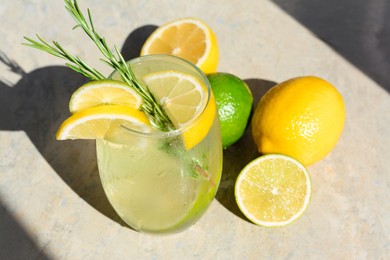 Tasty refreshing lemonade and ingredients on light table. Summer drink