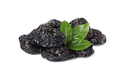 Photo of Heap of sweet dried prunes and green leaves on white background