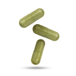 Image of Vitamin. Many capsules falling on white background