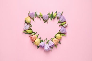 Flat lay composition with beautiful Eustoma flowers on pink background, space for text