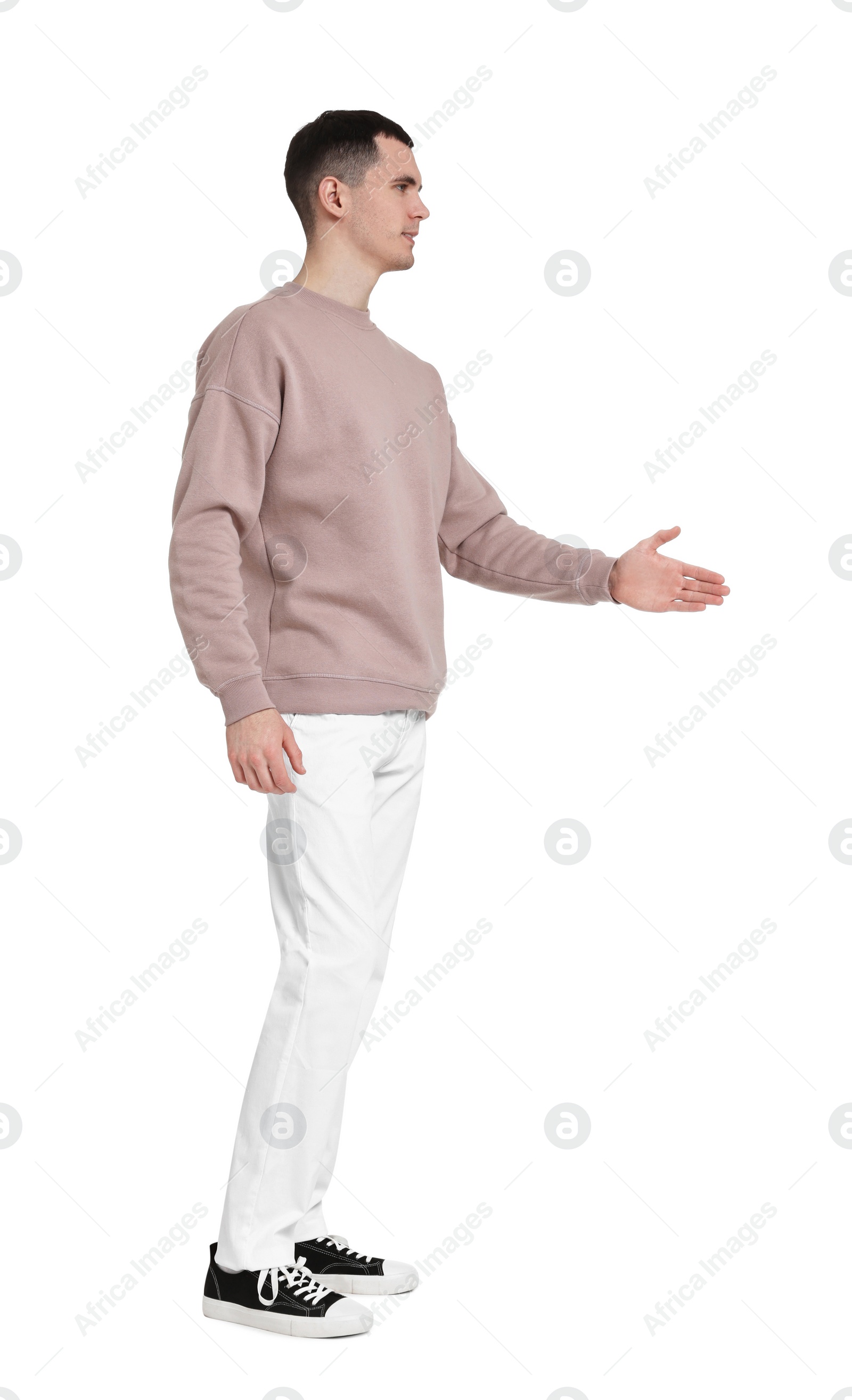 Photo of Handsome young man greeting someone on white background