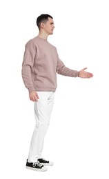 Photo of Handsome young man greeting someone on white background