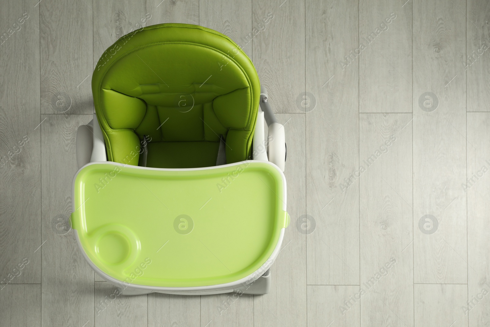 Photo of Green baby high chair indoors, top view