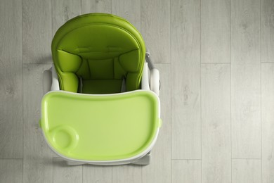 Green baby high chair indoors, top view