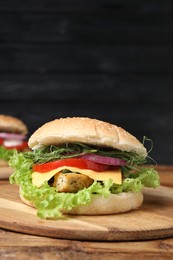 Photo of Delicious burger with tofu and fresh vegetables on wooden table