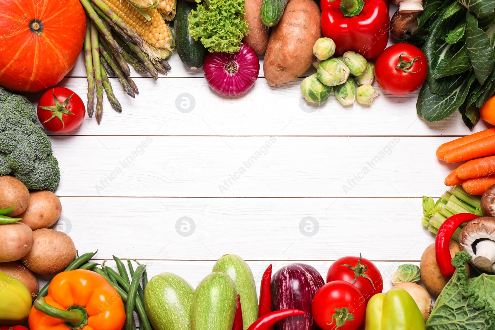 Photo of Frame of different fresh vegetables on white wooden table, flat lay. Space for text