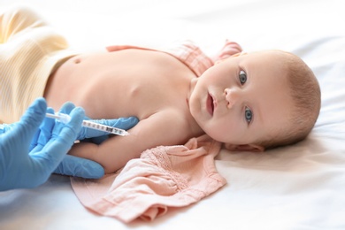 Doctor vaccinating baby in clinic