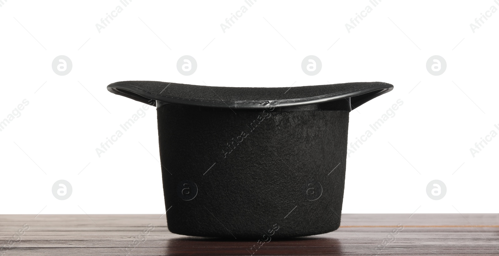 Photo of Magician's hat on wooden table against white background