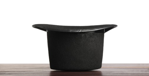 Magician's hat on wooden table against white background