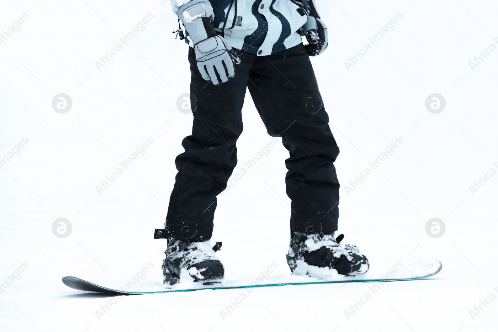 Photo of Snowboarder on slope at resort, closeup. Winter vacation