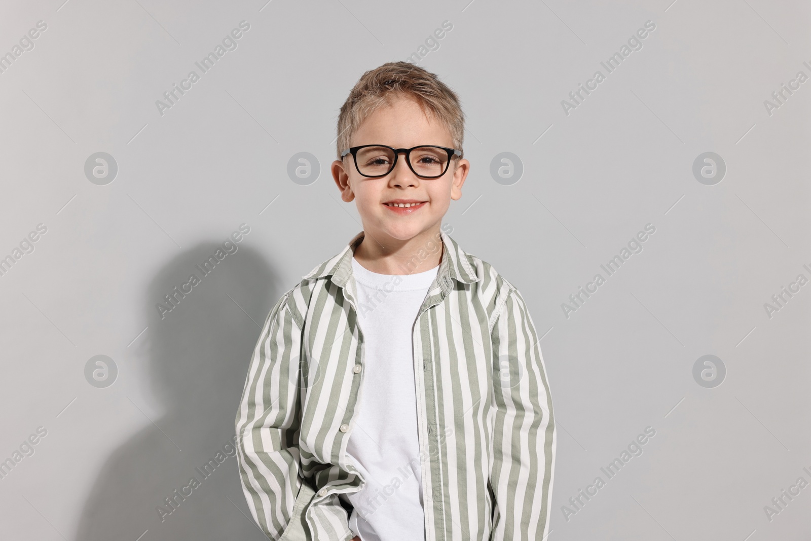 Photo of Fashion concept. Stylish boy posing on light grey background