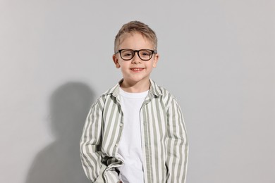 Fashion concept. Stylish boy posing on light grey background