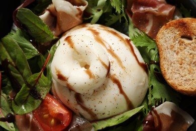 Photo of Delicious burrata salad with tomatoes and prosciutto, closeup