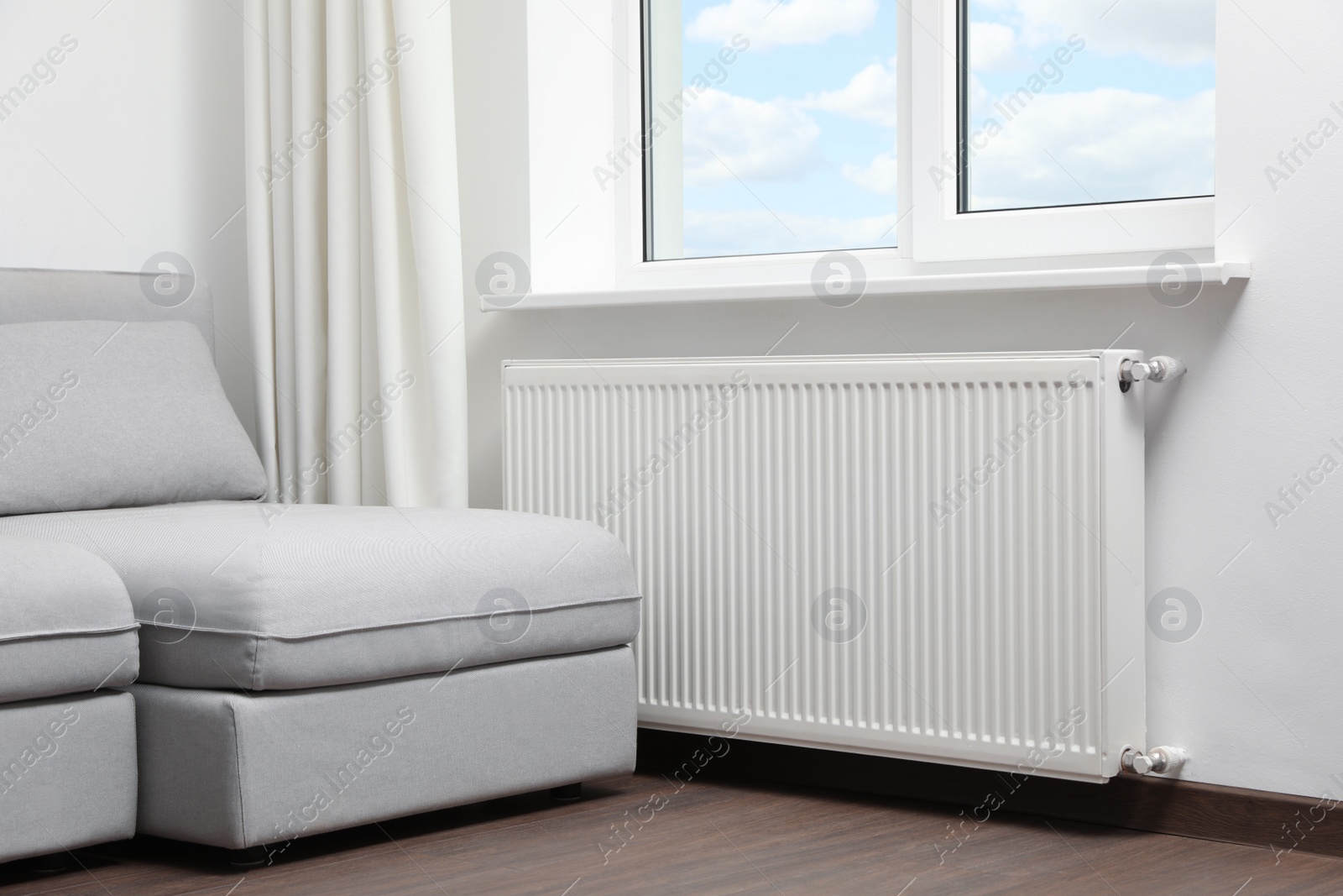 Photo of Modern radiator at home. Central heating system