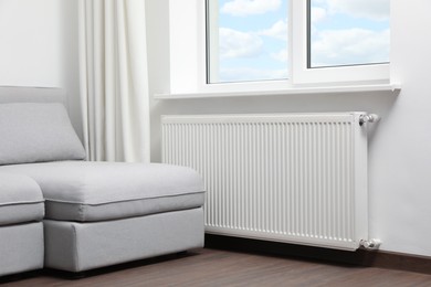 Photo of Modern radiator at home. Central heating system