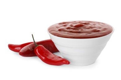 Photo of Bowl with red sauce and fresh chili peppers isolated on white