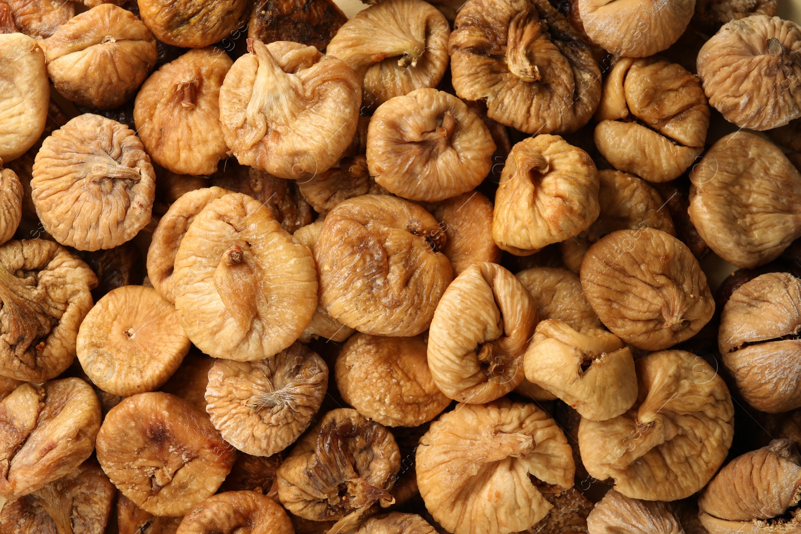 Photo of Many tasty dried figs as background, top view