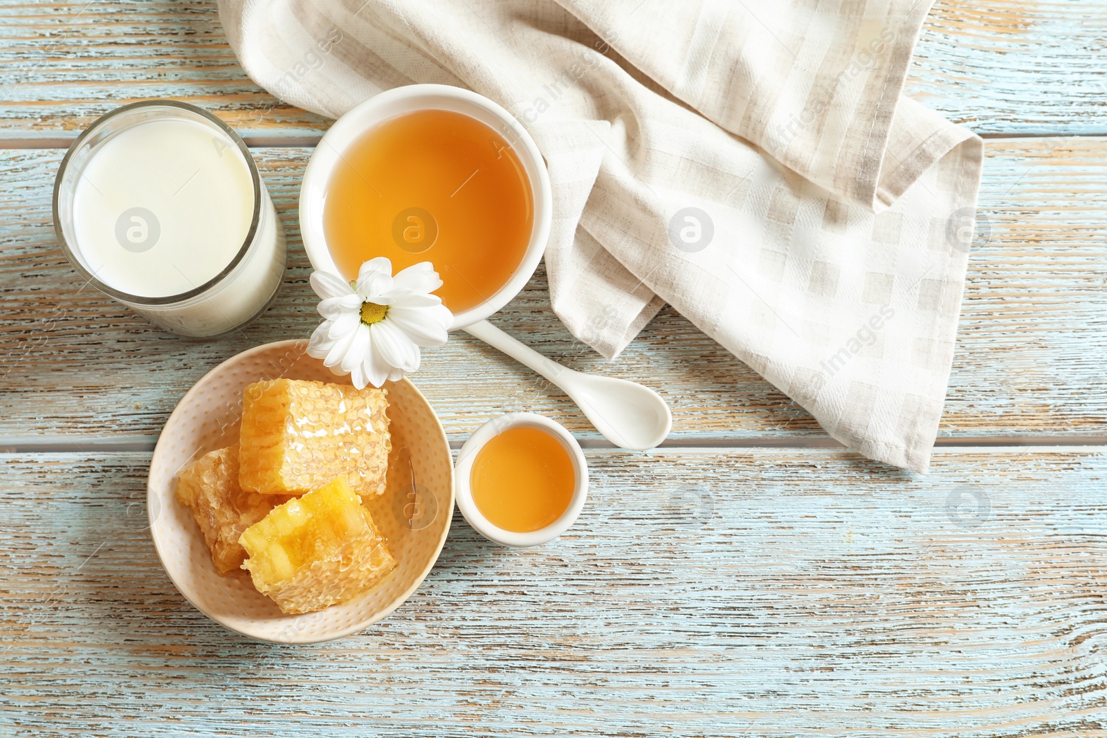 Photo of Beautiful composition with milk and honey on wooden background, top view