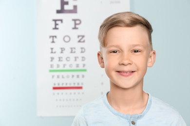 Photo of Cute little boy in ophthalmologist office