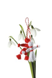 Photo of Beautiful snowdrops with traditional martisor on white background. Symbol of first spring day