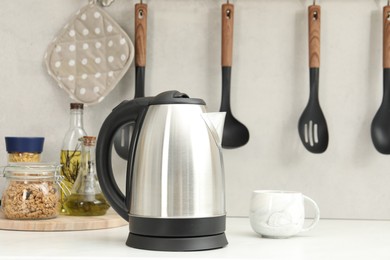 Electric kettle and cup on counter in kitchen