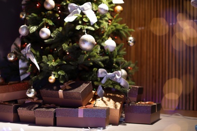 Photo of Beautiful Christmas tree and gift boxes in room